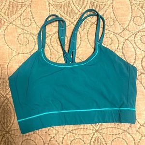 Janji teal sports bra with spaghetti straps. Barely worn as it is too big.